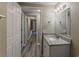 Bathroom sink with granite vanity, decorative light, and hallway view at 1084 Doyle Rd, Deltona, FL 32725
