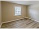 Bedroom with wood flooring and window view to outside at 1084 Doyle Rd, Deltona, FL 32725
