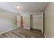 Neutral bedroom featuring wood-look floors, an open closet, and a door to the ensuite at 1084 Doyle Rd, Deltona, FL 32725