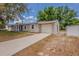 Charming single-story home with an attached garage and concrete driveway in the front yard at 1084 Doyle Rd, Deltona, FL 32725