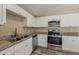 Spacious kitchen features stainless steel appliances, granite countertops, and white cabinets at 1084 Doyle Rd, Deltona, FL 32725
