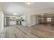 Open kitchen and living room features stainless steel appliances and light wood flooring at 1084 Doyle Rd, Deltona, FL 32725