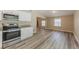 Well-lit kitchen features stainless steel appliances and open space to living room at 1084 Doyle Rd, Deltona, FL 32725