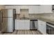 Modern kitchen features stainless steel appliances, granite countertops, and white cabinets at 1084 Doyle Rd, Deltona, FL 32725