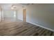 Open living area with wood-look floors, neutral walls, and lots of natural light at 1084 Doyle Rd, Deltona, FL 32725