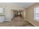 Spacious living room featuring wood-look floors and neutral walls that lead to kitchen at 1084 Doyle Rd, Deltona, FL 32725