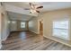 Living room with neutral walls and wood-look floors showcasing the open floor plan at 1084 Doyle Rd, Deltona, FL 32725