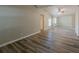 Spacious living room featuring wood-look flooring, neutral walls and an open floor plan at 1084 Doyle Rd, Deltona, FL 32725