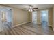 Main bedroom with wood-look flooring, neutral walls, and open bathroom entrance at 1084 Doyle Rd, Deltona, FL 32725