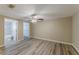 Main bedroom featuring wood-look floors, ceiling fan, and en suite bathroom at 1084 Doyle Rd, Deltona, FL 32725