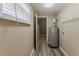 Utility room featuring tile floors, water heater, and exterior access at 1084 Doyle Rd, Deltona, FL 32725