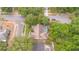 Beautiful aerial view of home with screened pool, lush greenery, and mature trees on a quiet street at 1100 Oday Dr, Winter Springs, FL 32708