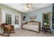 This bedroom leads to the outdoor pool via glass French doors with a neutral floor, and comfortable furniture at 1100 Oday Dr, Winter Springs, FL 32708
