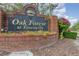 Oak Forest at Tuscawilla neighborhood sign with well-maintained landscaping at 1100 Oday Dr, Winter Springs, FL 32708