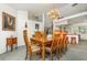 Dining room featuring a chandelier and an open view to the kitchen at 1100 Oday Dr, Winter Springs, FL 32708