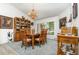 Bright dining room with carpet, chandelier, and a view of the landscaped backyard at 1100 Oday Dr, Winter Springs, FL 32708
