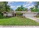 Charming single-story home featuring a well-manicured lawn and a two-car garage at 1100 Oday Dr, Winter Springs, FL 32708