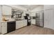 Clean kitchen featuring stainless steel appliances, wood laminate flooring, and white cabinets at 1100 Oday Dr, Winter Springs, FL 32708