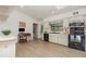 Well-lit kitchen with wood laminate flooring, black appliances, and an eat-in area at 1100 Oday Dr, Winter Springs, FL 32708