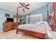 Serene main bedroom featuring a four-poster bed, TV, and an en-suite bathroom at 1100 Oday Dr, Winter Springs, FL 32708