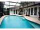 Inviting screened-in pool area with plenty of space for entertaining, and lush landscaping at 1100 Oday Dr, Winter Springs, FL 32708