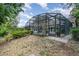 Screened-in pool area with lovely landscaping and a covered patio at 1100 Oday Dr, Winter Springs, FL 32708