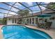 The screened-in pool area features a pool, lush greenery and ample room for outdoor entertaining at 1100 Oday Dr, Winter Springs, FL 32708