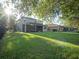Expansive backyard with a well-maintained lawn and a screened-in porch perfect for outdoor relaxation and entertaining at 11742 Chateaubriand Ave, Orlando, FL 32836