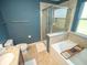 Stylish bathroom showcasing a soaking tub, glass-enclosed shower, and modern fixtures at 11742 Chateaubriand Ave, Orlando, FL 32836