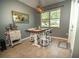 Cozy dining area with modern lighting, a charming table setting, and a picturesque view through the window, perfect for Gathering meals at 11742 Chateaubriand Ave, Orlando, FL 32836