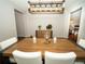 Dining room with modern light fixture, stylish buffet, and seating for six at 11742 Chateaubriand Ave, Orlando, FL 32836