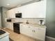 Well-equipped kitchen boasts white cabinets, granite counters, and modern appliances at 11742 Chateaubriand Ave, Orlando, FL 32836