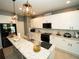 Bright kitchen features white cabinetry, granite countertops, and modern appliances at 11742 Chateaubriand Ave, Orlando, FL 32836
