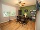 This office features dark wooden floors, a ceiling fan, and a large shuttered window at 11742 Chateaubriand Ave, Orlando, FL 32836