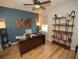 Bright office with wood floors, desk, shelves, and modern decor accents against a striking blue accent wall at 11742 Chateaubriand Ave, Orlando, FL 32836