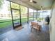 Inviting screened porch with tile flooring, ceiling fans, and peaceful backyard views, perfect for outdoor dining at 11742 Chateaubriand Ave, Orlando, FL 32836