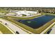 A panoramic aerial view of a pond near a school, set within the community's neighborhood at 11957 Vermillion Ave, Windermere, FL 34786