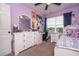 Whimsical purple bedroom featuring a ceiling fan, large dresser and blue curtains at 11957 Vermillion Ave, Windermere, FL 34786