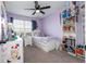Cozy bedroom with natural light, ceiling fan, and decorative shelving at 11957 Vermillion Ave, Windermere, FL 34786
