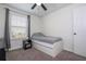 Neutral carpeted bedroom with a ceiling fan and a window with blinds and curtains at 11957 Vermillion Ave, Windermere, FL 34786