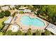 Overhead shot of a large community swimming pool with seating and recreation areas at 11957 Vermillion Ave, Windermere, FL 34786
