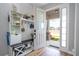 Charming entryway with a storage bench and bright natural light streaming through the open door at 11957 Vermillion Ave, Windermere, FL 34786