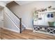 Inviting entryway featuring wood-look floors, storage solution, and a staircase at 11957 Vermillion Ave, Windermere, FL 34786