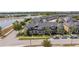 Aerial view of townhomes near a lake showing sidewalks, landscaping, and parked vehicles at 11957 Vermillion Ave, Windermere, FL 34786