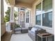 Inviting front porch featuring stone accents, comfortable seating, and ample natural light at 11957 Vermillion Ave, Windermere, FL 34786