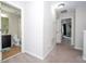 Upstairs hallway with carpet and doorways to the bathroom, bedroom, and stairway at 11957 Vermillion Ave, Windermere, FL 34786