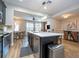 Eat-in kitchen with a quartz island, stainless steel appliances, and wood floors throughout at 11957 Vermillion Ave, Windermere, FL 34786