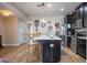 Bright eat-in kitchen boasts a quartz island, stainless appliances, and stylish wood floors throughout at 11957 Vermillion Ave, Windermere, FL 34786
