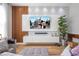 Modern living room featuring a large TV, sleek media console, and stylish decor at 11957 Vermillion Ave, Windermere, FL 34786