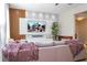Bright living room with a modern entertainment center and large windows at 11957 Vermillion Ave, Windermere, FL 34786